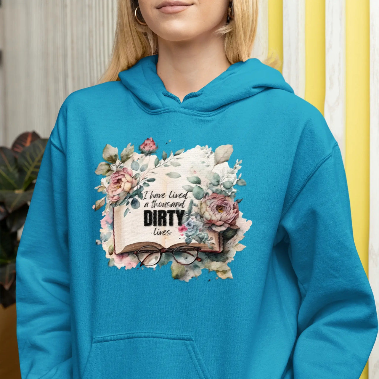 woman wearing a teal I Have Lived A 1000 Dirty Lives Hoodie V1