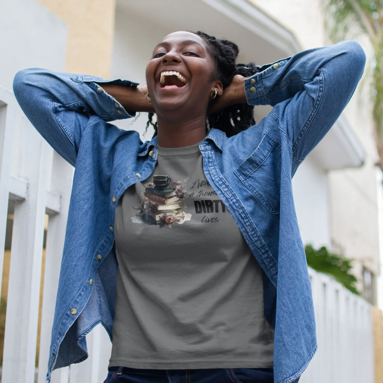 woman laughing while wearing a dark grey I have lived a 1000 dirty lives tshirt V2 