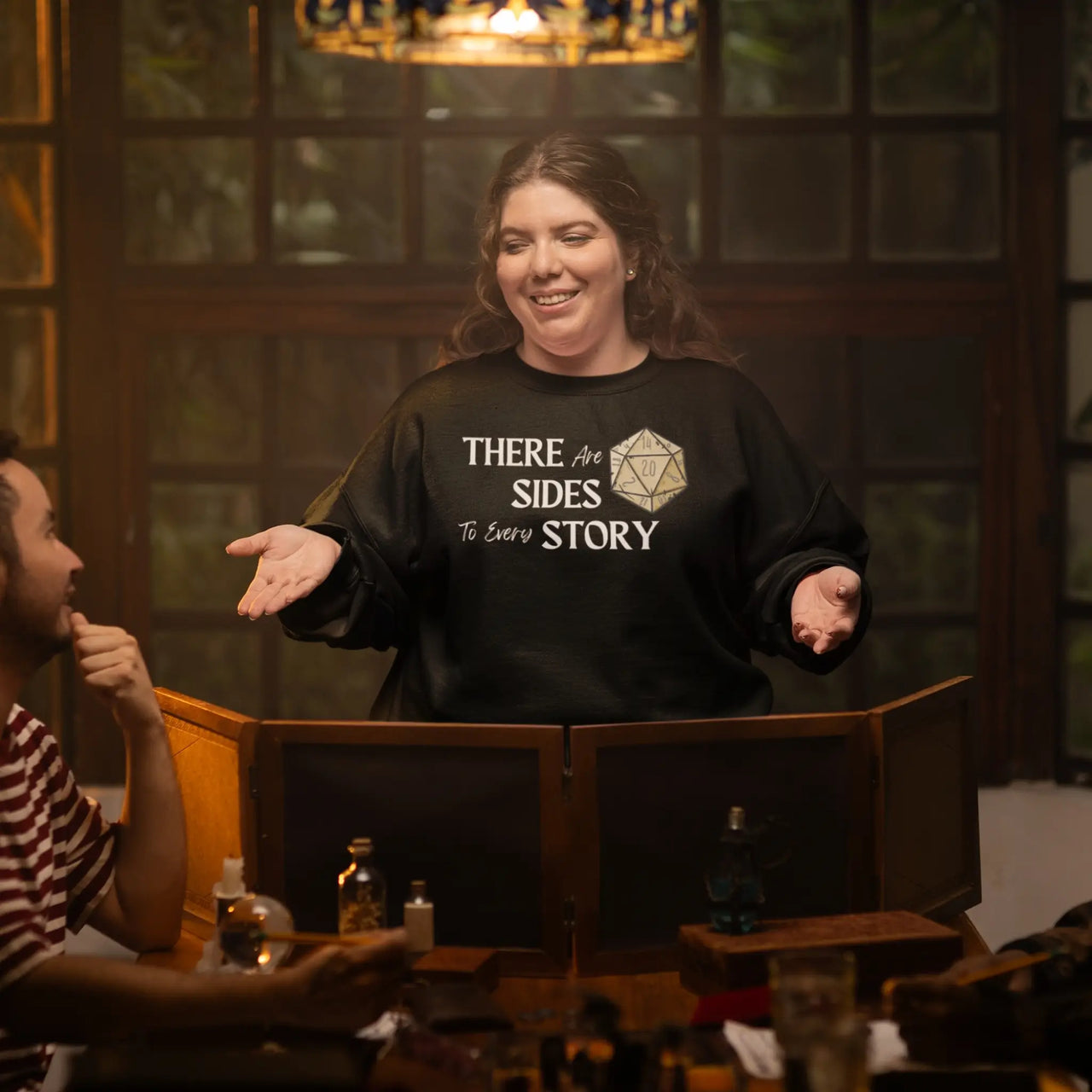 A Game master wearing a black There are 20 sides to every story sweatshirt