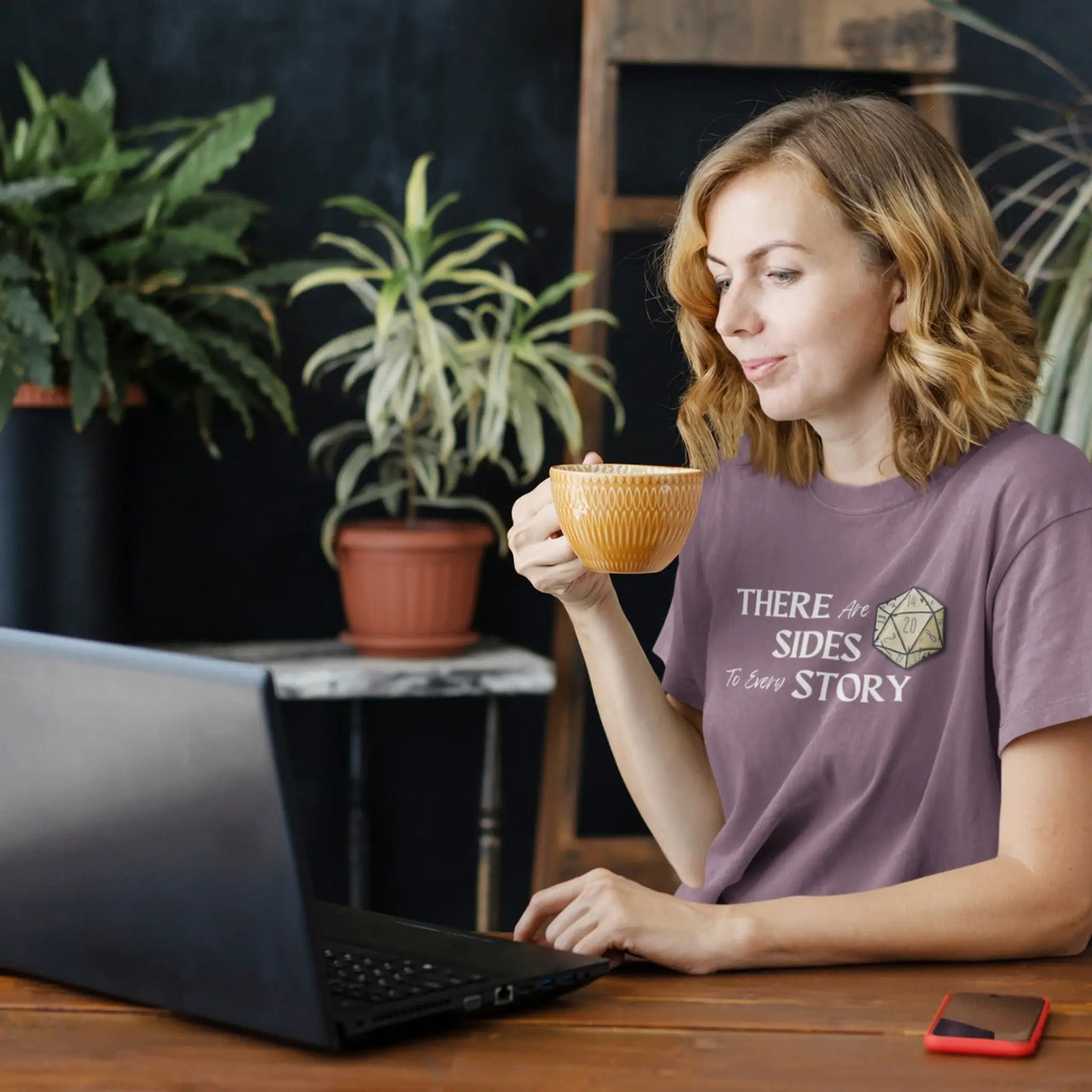 woman working wearing a maroon There are 20 sides to every story tshirt with white text