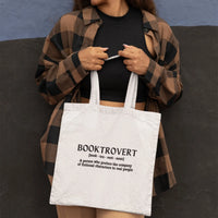 Thumbnail for woman carrying a white booktrovert tote in front of her