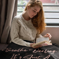 Thumbnail for Woman snuggled up under the The Breathe Darling Blanket