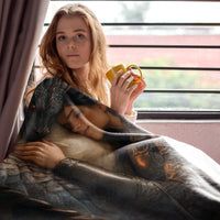 Thumbnail for woman drinking a hot beverage while wrapped in the Dragon Bond Blanket