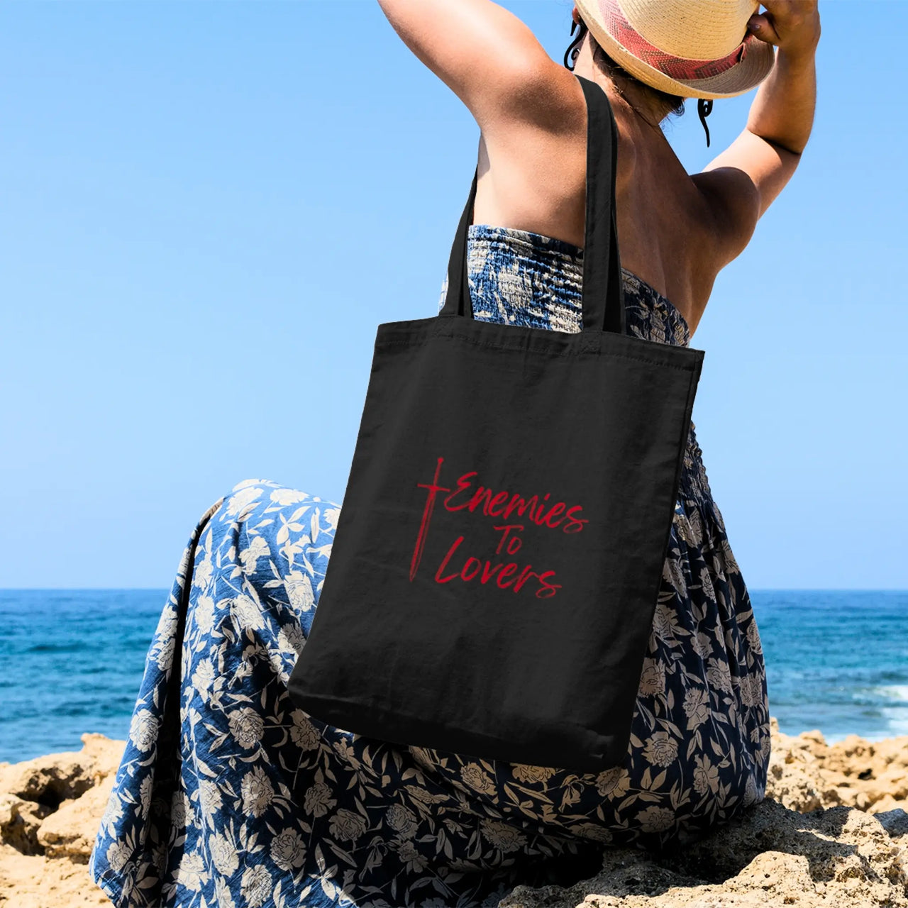 woman with her Enemies To Lovers tote red on black