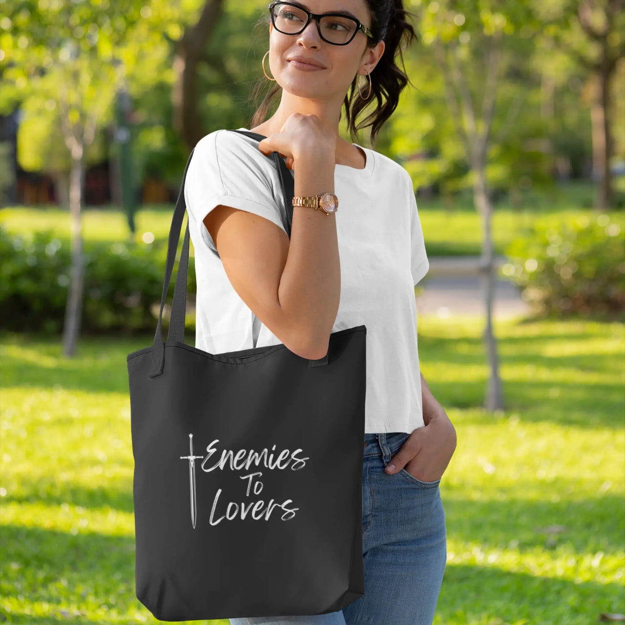 reader with her Enemies To Lovers tote white on black