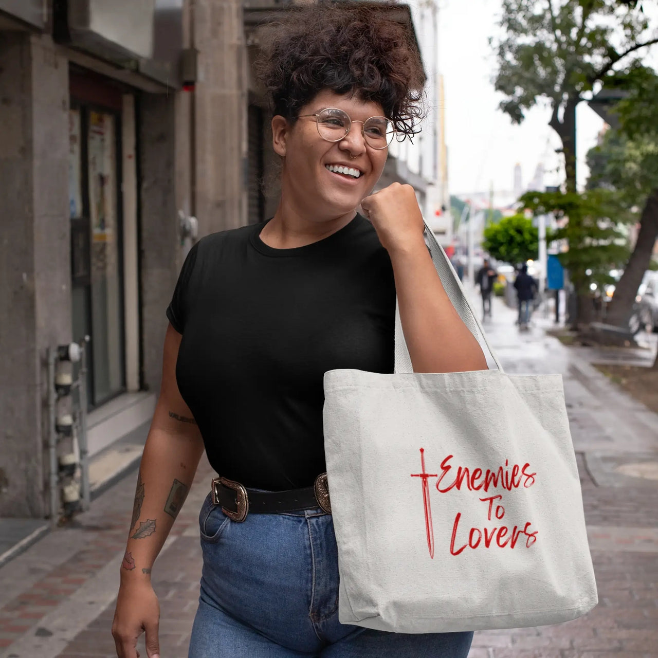 woman carrying an Enemies To Lovers tote red on white