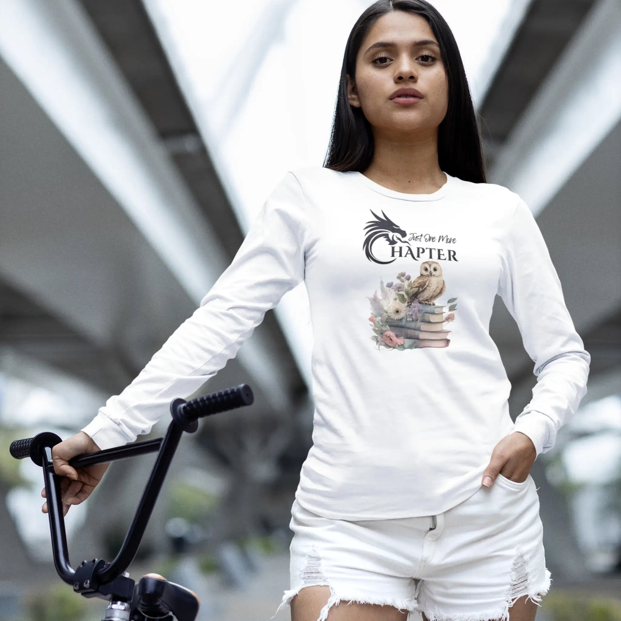 woman wearing a Just One More Chapter long sleeve shirt V2 in white with a small owl