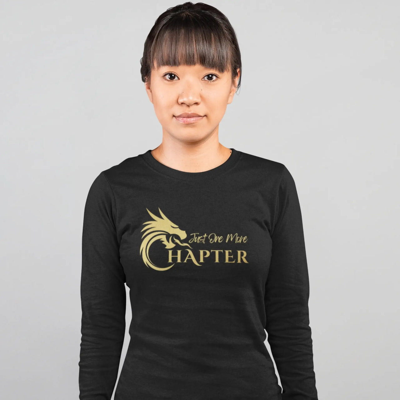 woman wearing the Just One More Chapter Logo design long sleeve in black with gold text