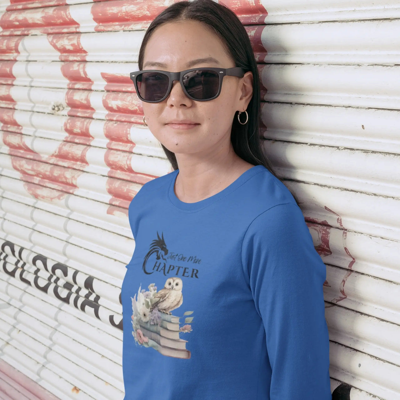 woman in sunglasses wearing a Just One More Chapter long sleeve shirt V2 in blue with a small owl