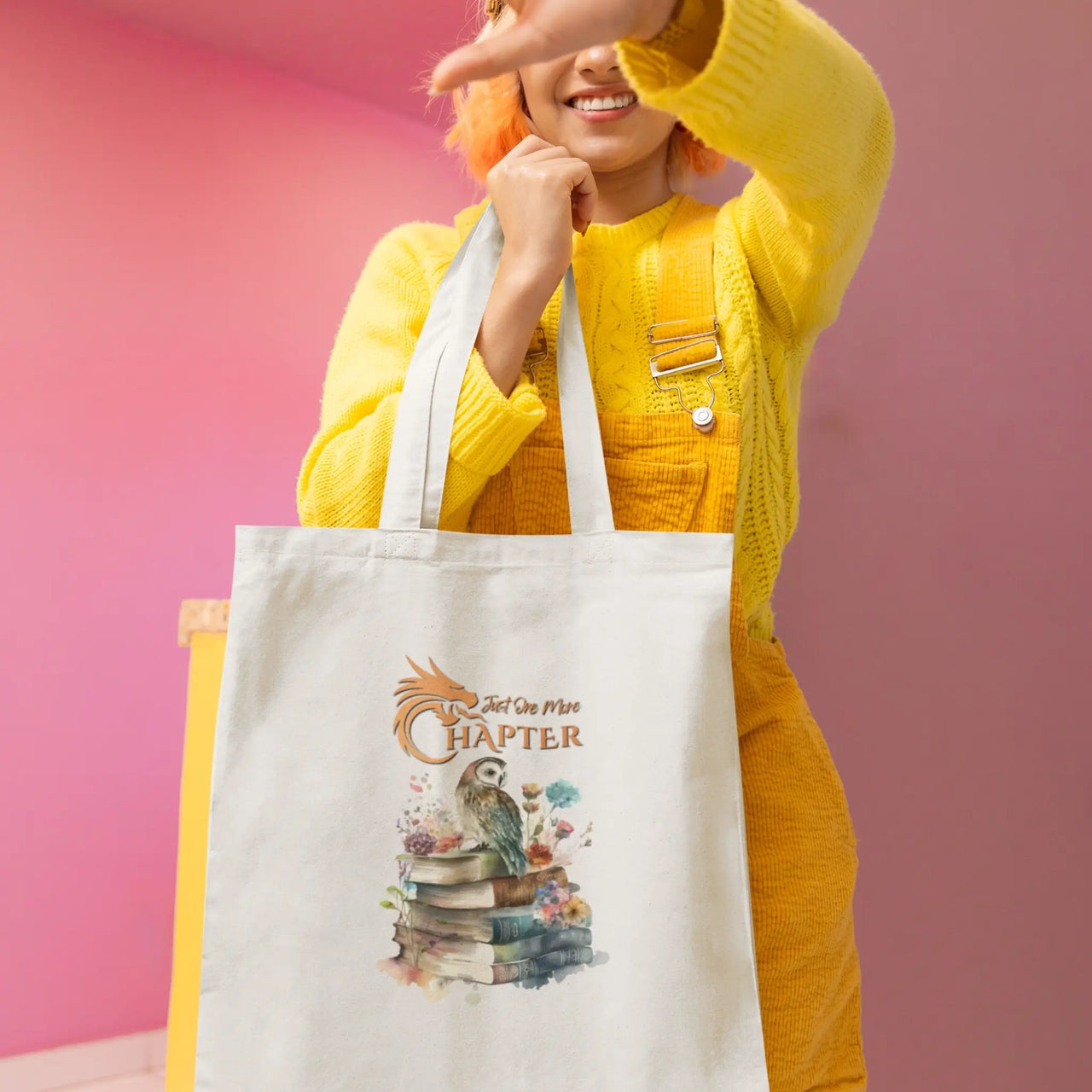 a younf woman with the Just One More Chapter Owl and Book design on a white tote v3