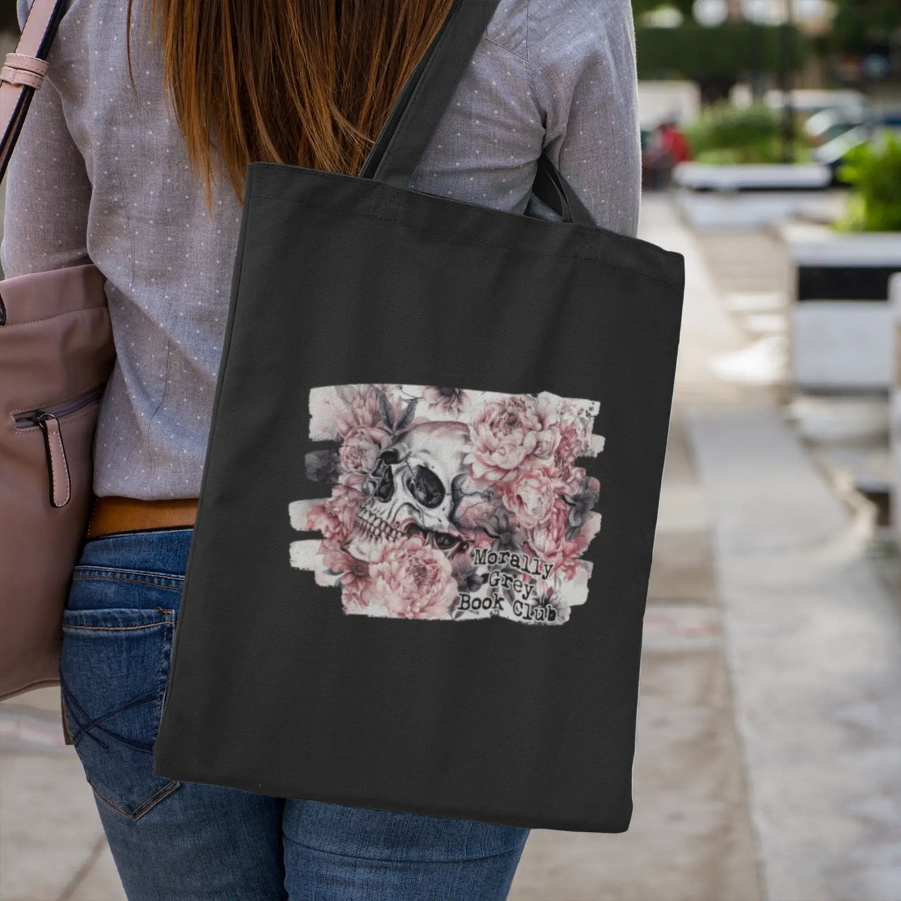 woman walking with her black morally grey tote