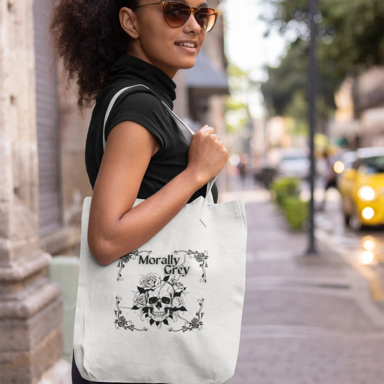 woman using her white morally grey tote