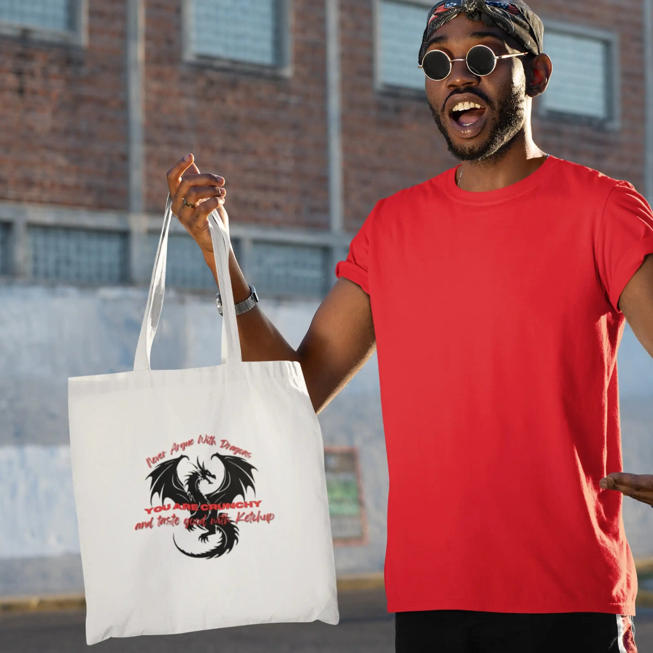 an excited guy carrying a Never Argue with dragons tote bag