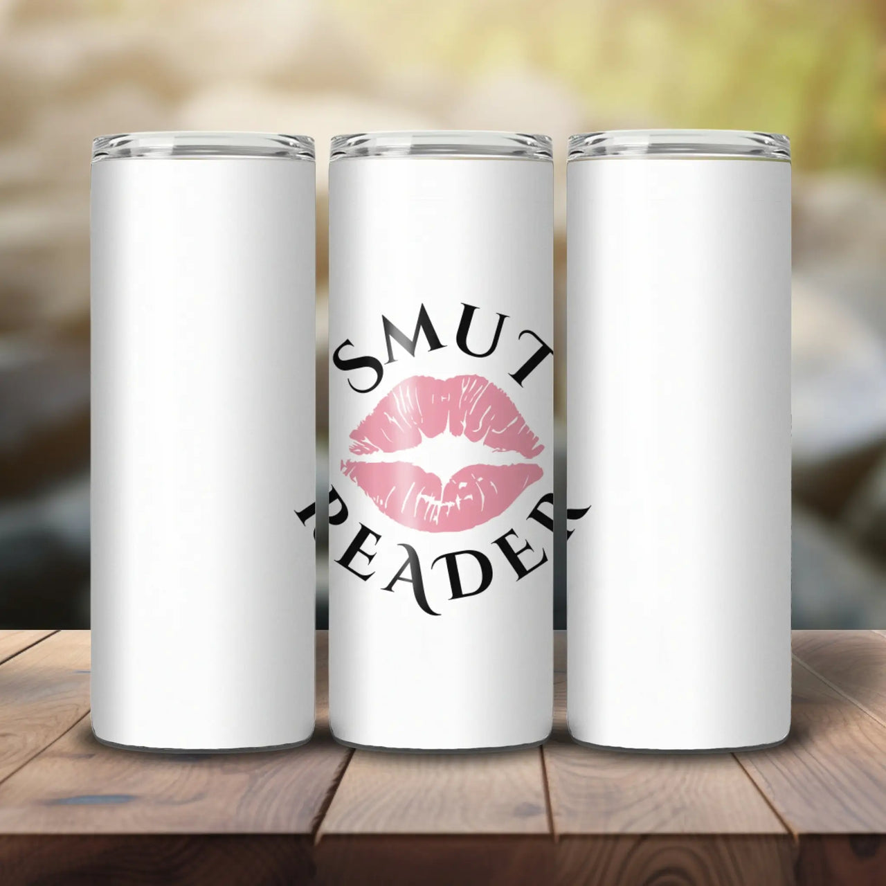 Smut Reader Skinny tumbler on a wooden table