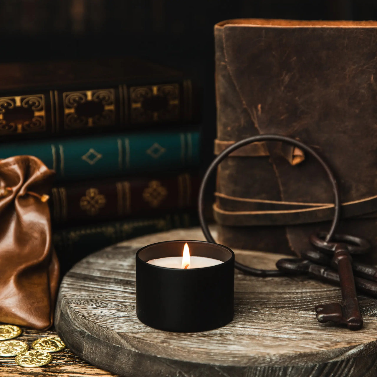 lit candle with keys and coins