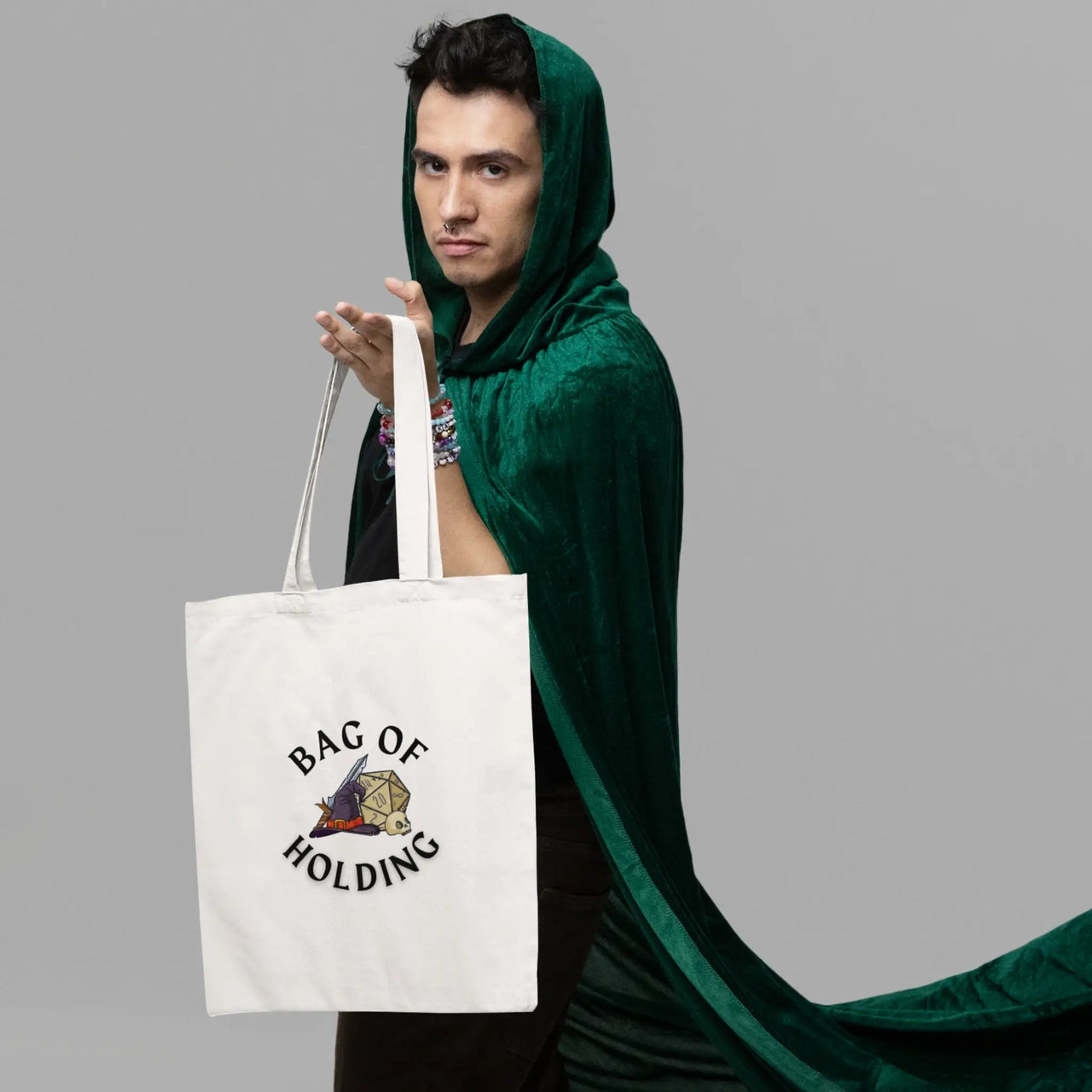 a guy in a green cloak with a white bag of holding themed tote