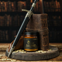 Thumbnail for Black Dragon Candle next to coins and a dagger