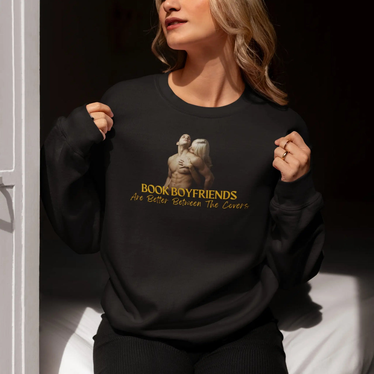 woman wearing a Book boyfriends are better between the covers sweatshirt