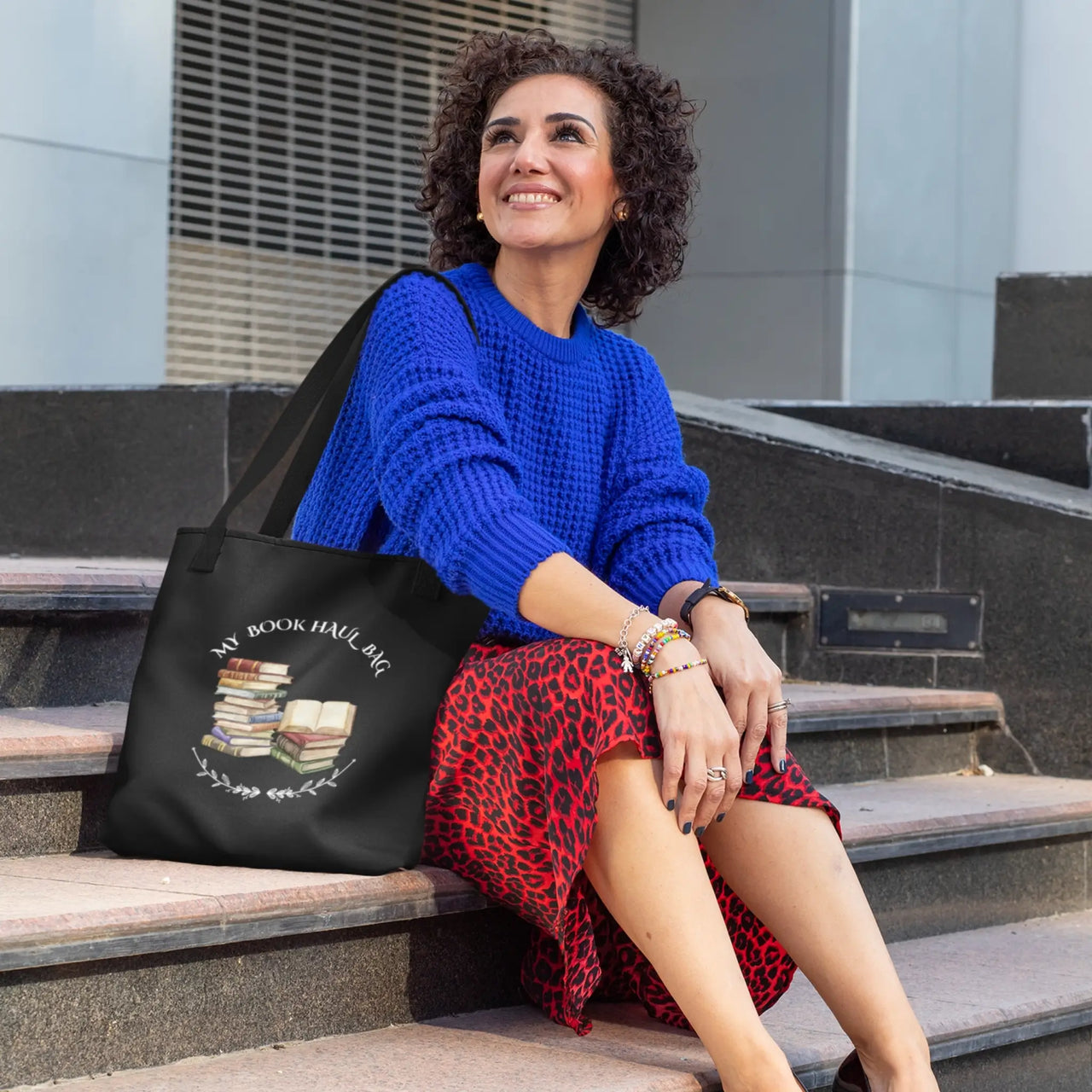 black tote with a woman sitting on steps