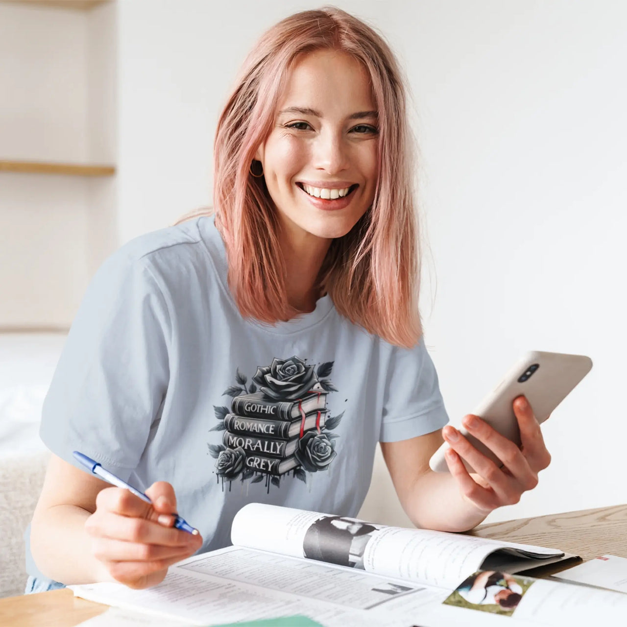 smiling woman wearing a light blue books and roses t-shirt