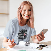 Thumbnail for smiling woman wearing a light blue books and roses t-shirt