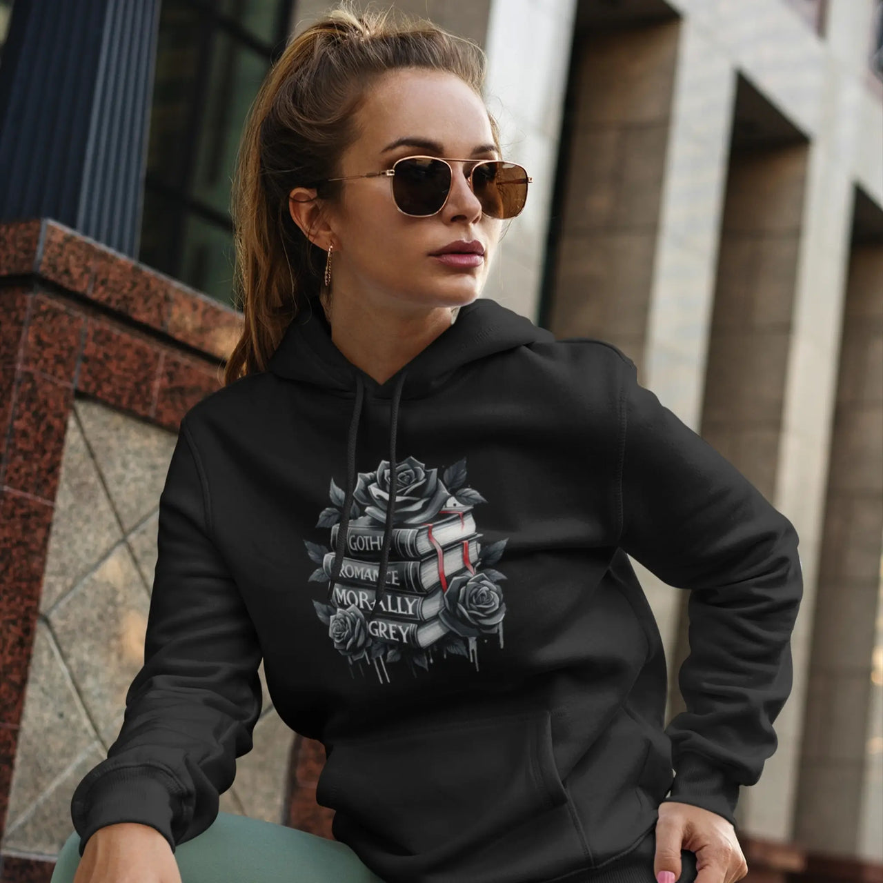 a young woman in sunglasses wearing a Black Books and Roses hoodie