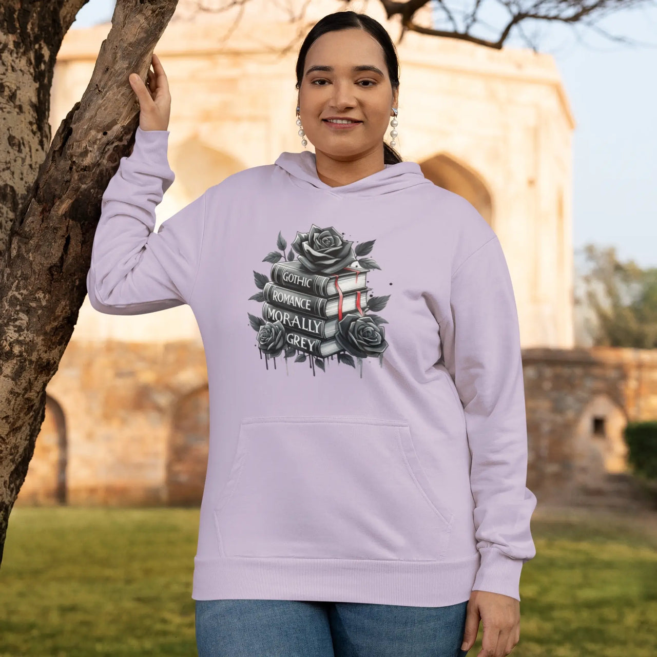 a woman wearing an orchid colored Books and Roses hoodie