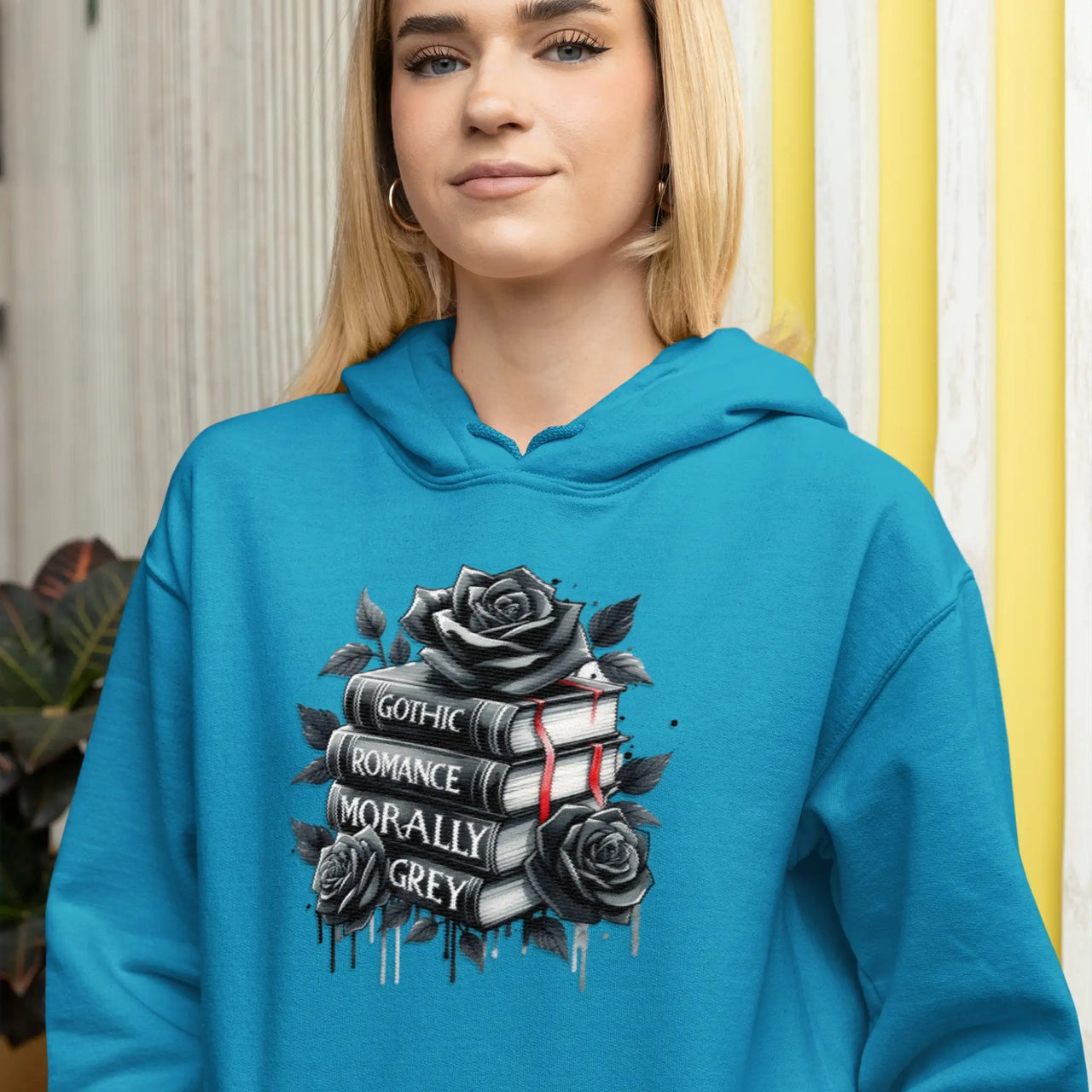 w woman wearing the teal Books and Roses hoodie