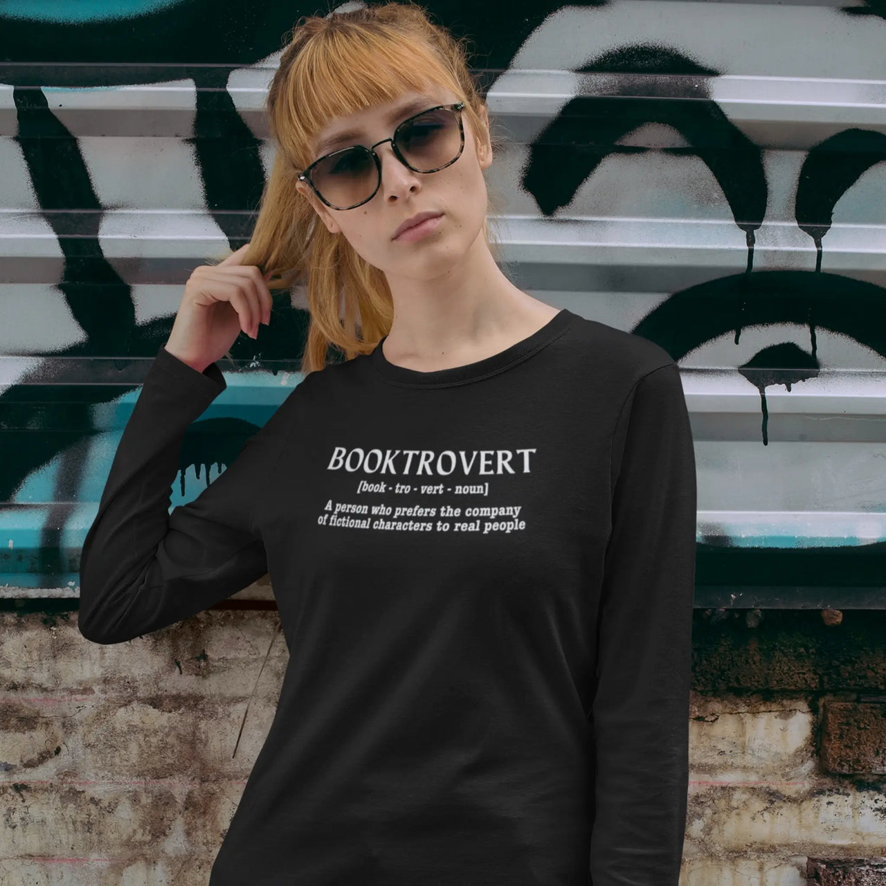 woman with shades on wearing a Booktrovert long sleeve tshirt in black