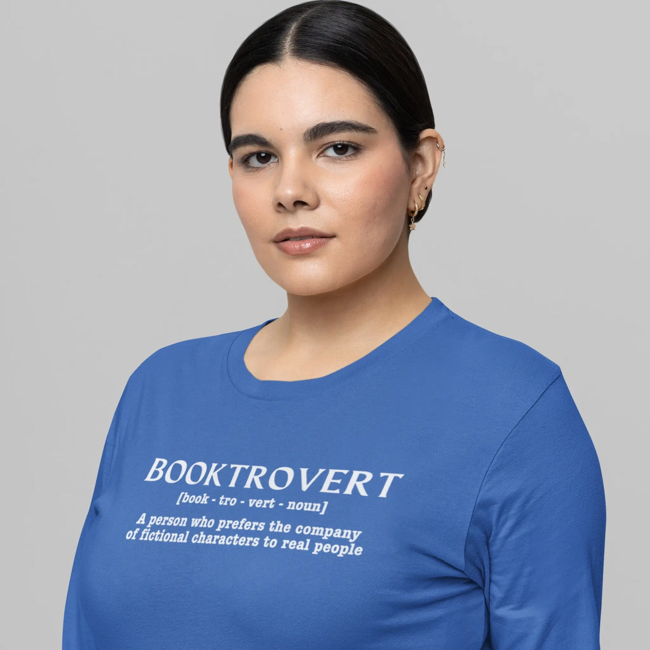 an avid reader wearing a Booktrovert long sleeve tshirt in blue with white writing