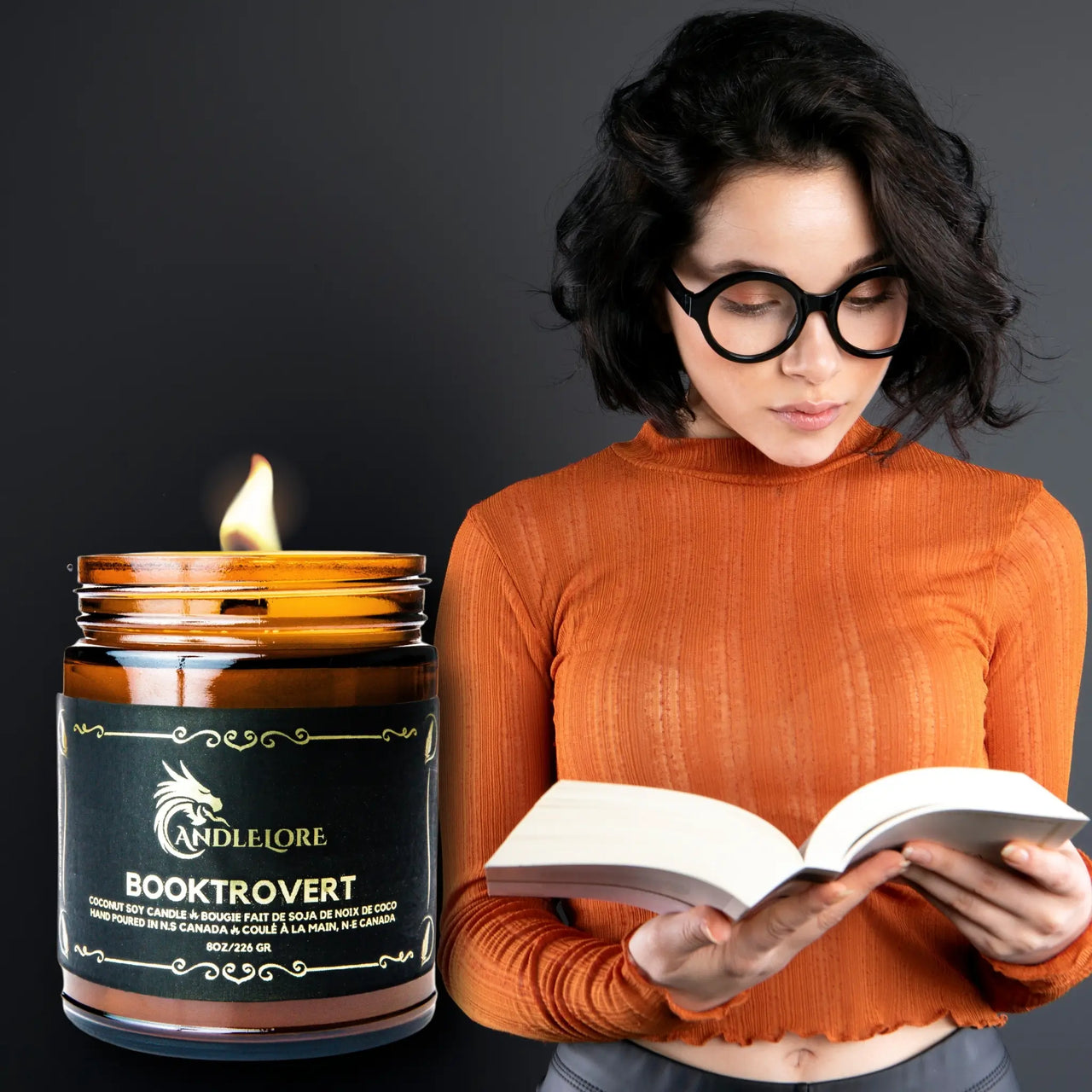 Booktrovert Candle with a person reading intently beside it