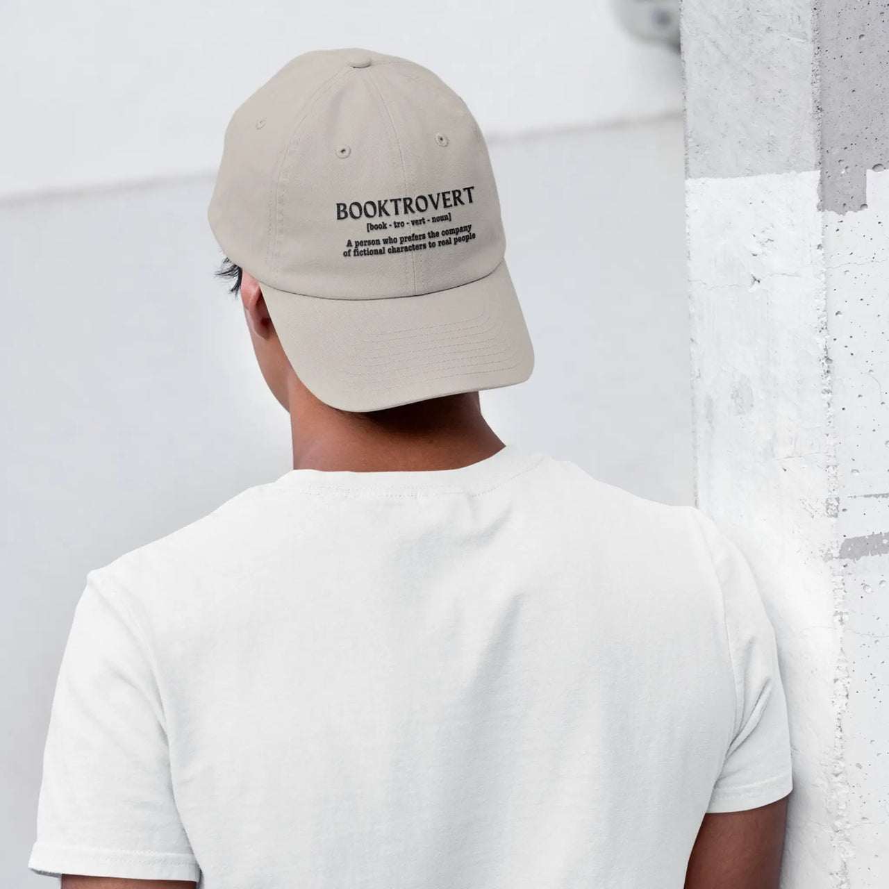 a guy wearing a Booktrovert cap in beige