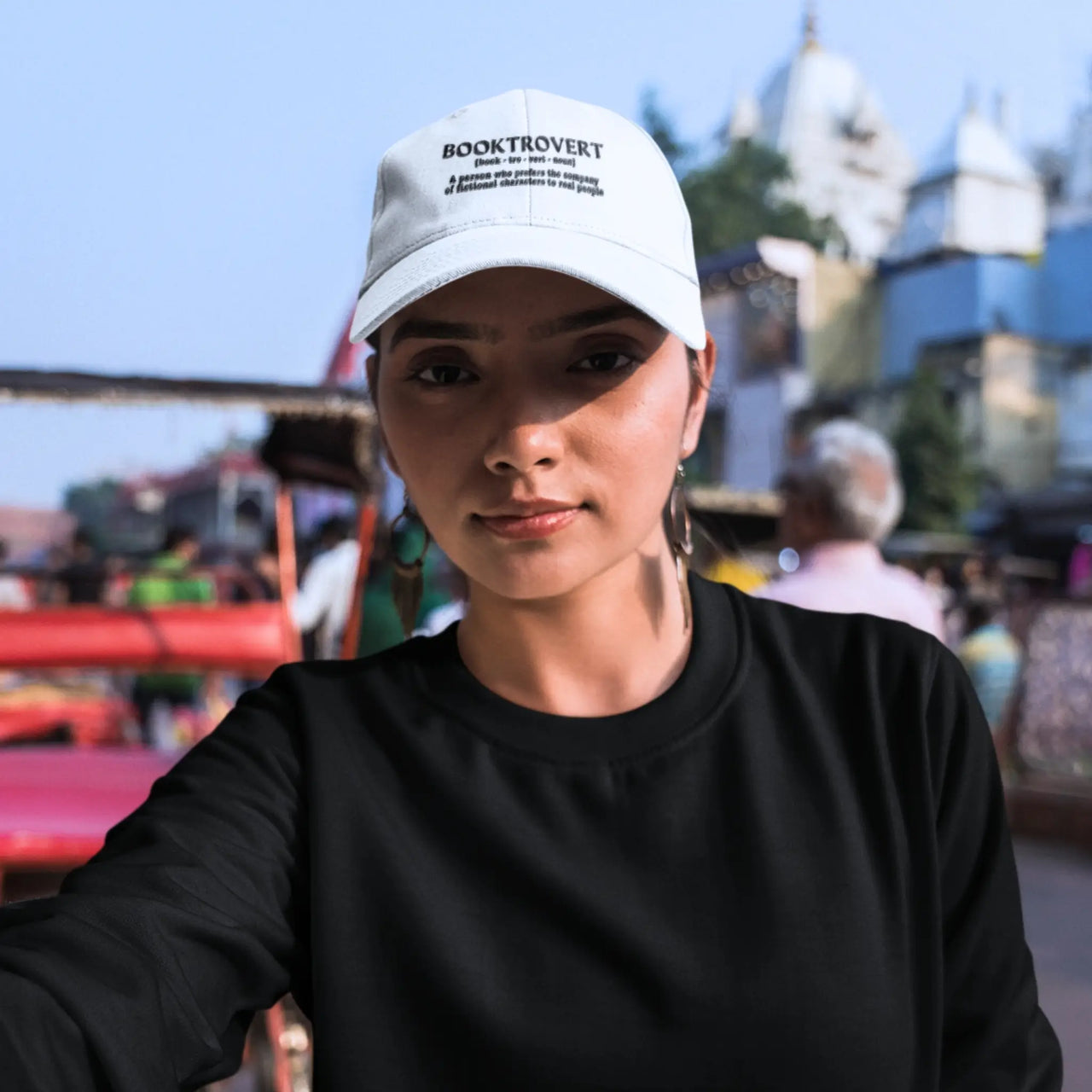 woman wearing a Booktrovert cap in light blue