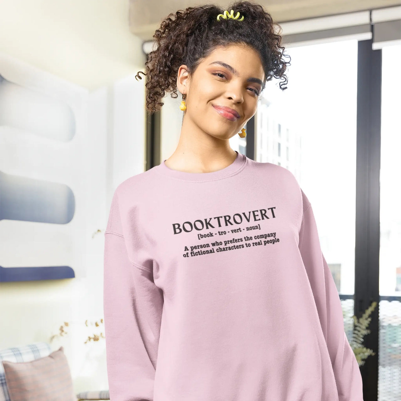 woman wearing a Pink Booktrovert Sweatshirt