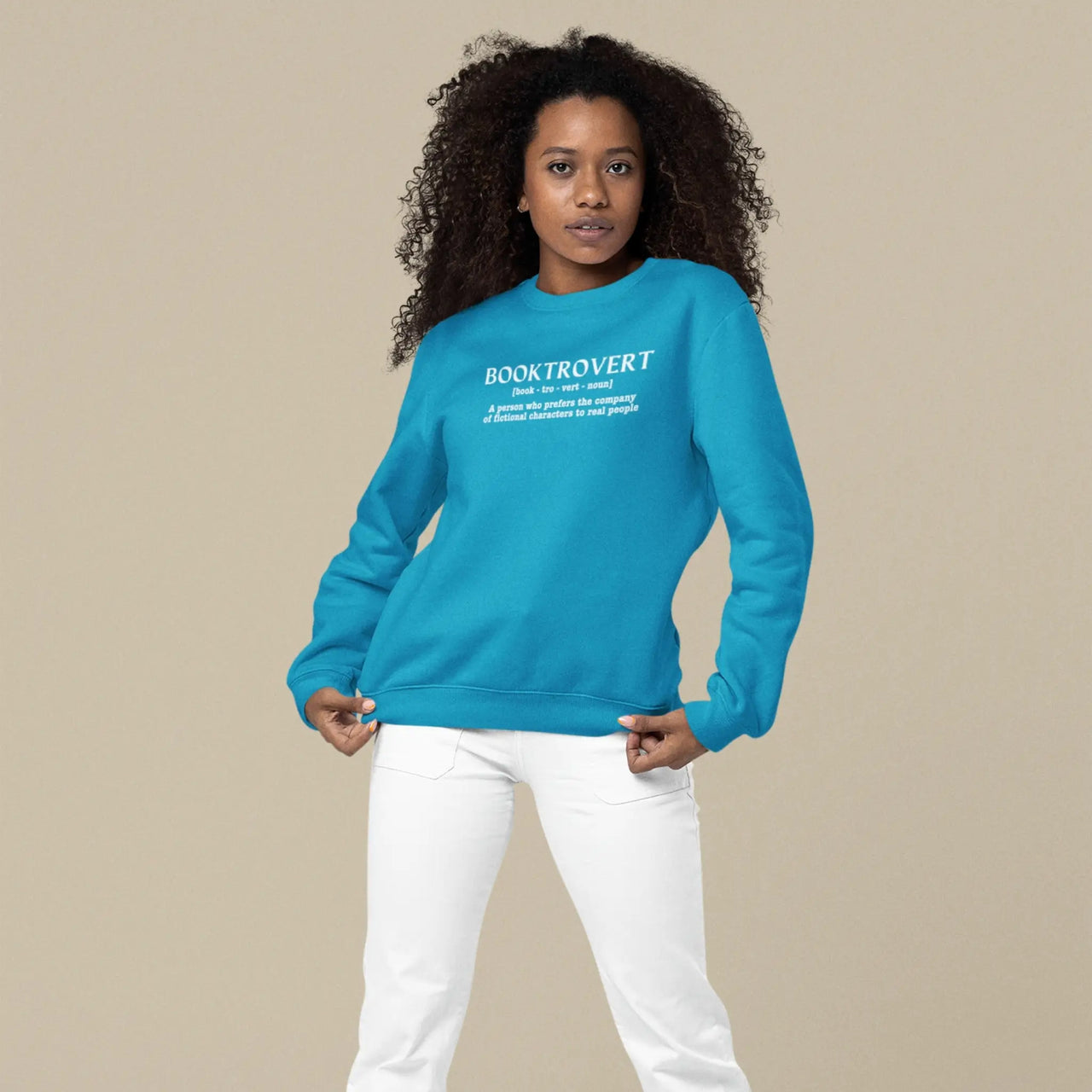 woman posing in a Teal Booktrovert Sweatshirt with white text