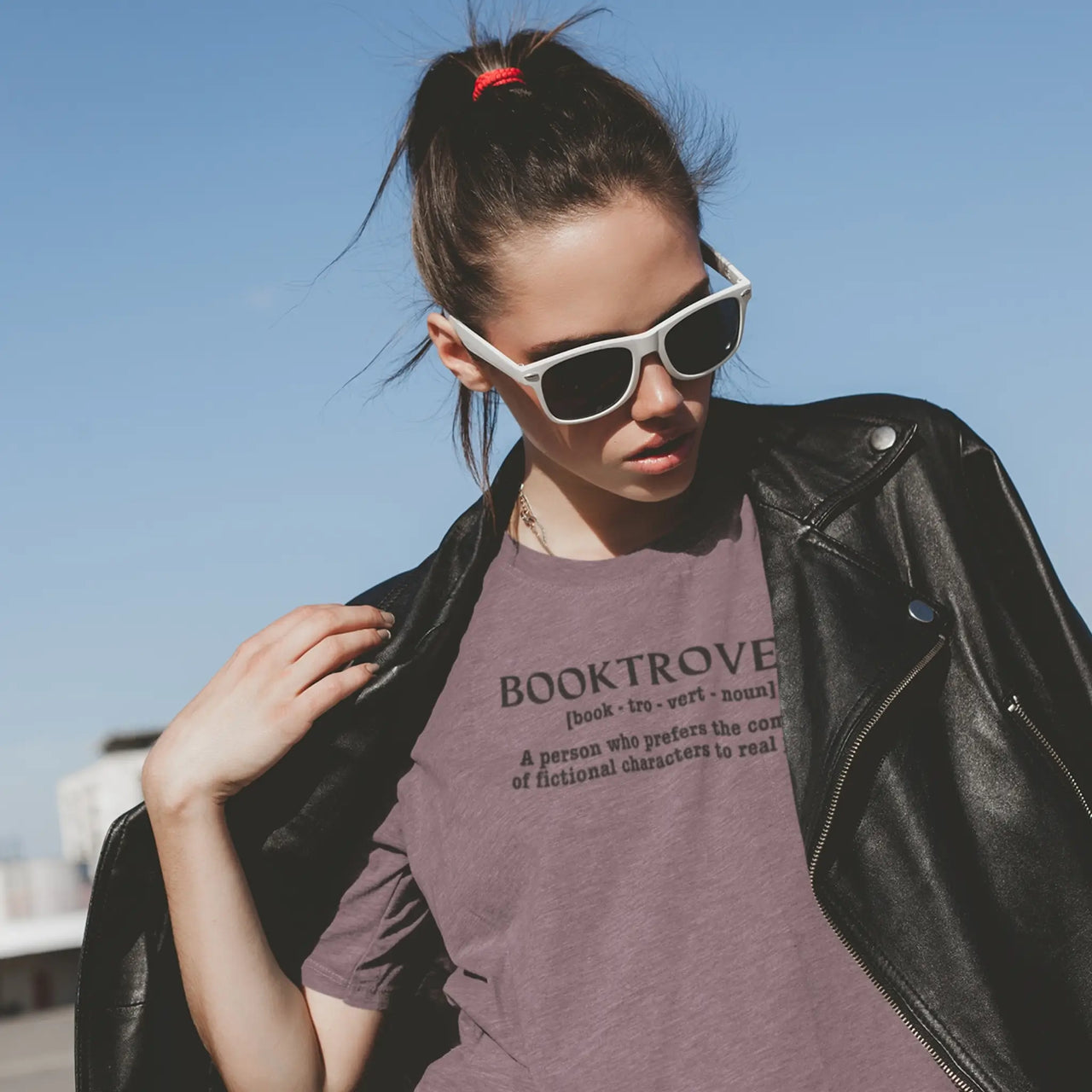 woman wearing a heather maroon booktrovert tshirt