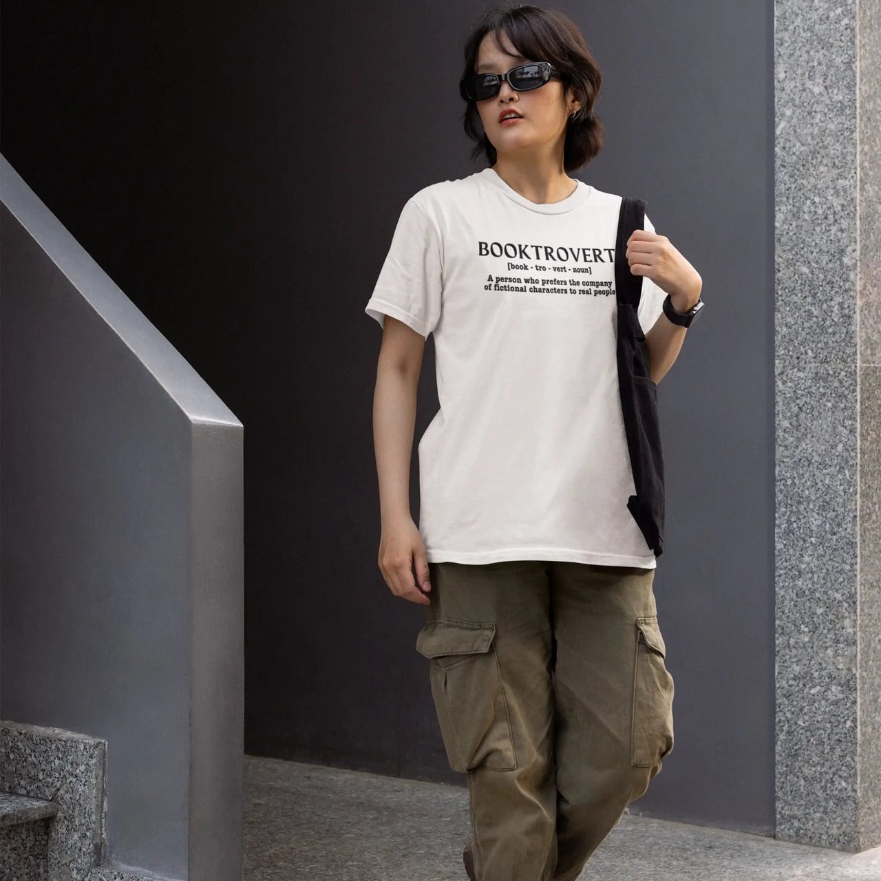 woman wearing a white booktrovert tshirt