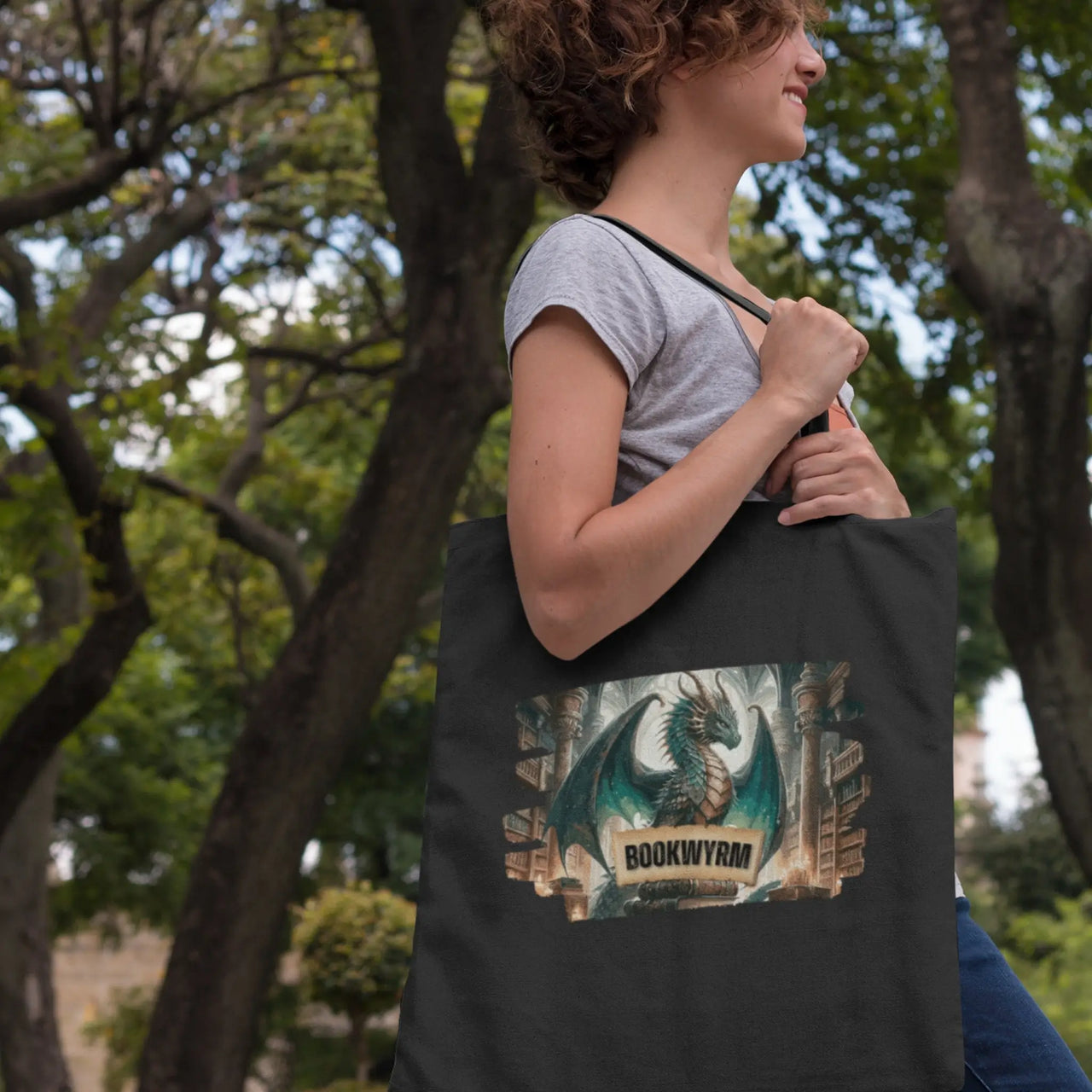 a young woman walking with her black bookwyrm tote bag