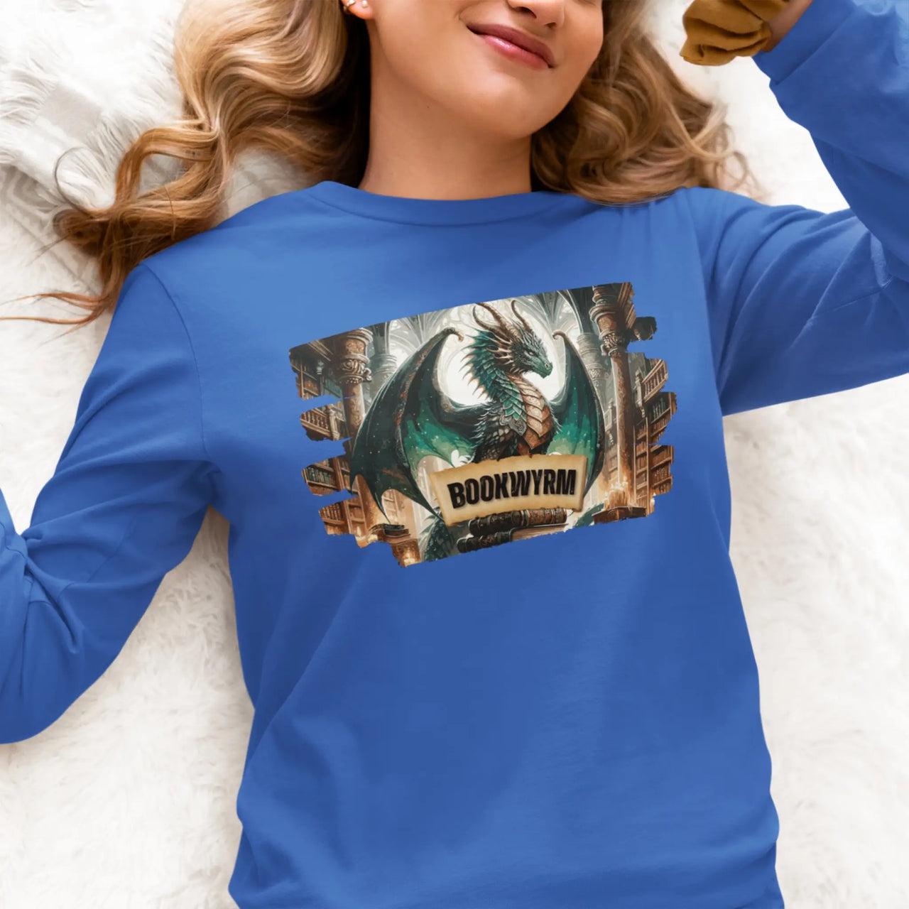 a woman laying down while wearing a blue bookwyrm long sleeve t