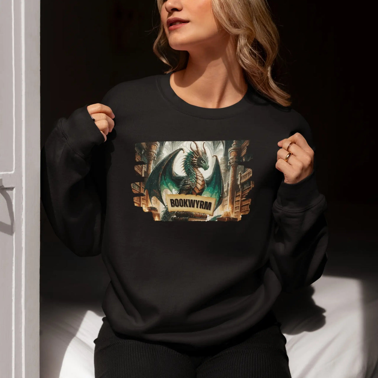 woman showing off her black Bookwyrm sweatshirt