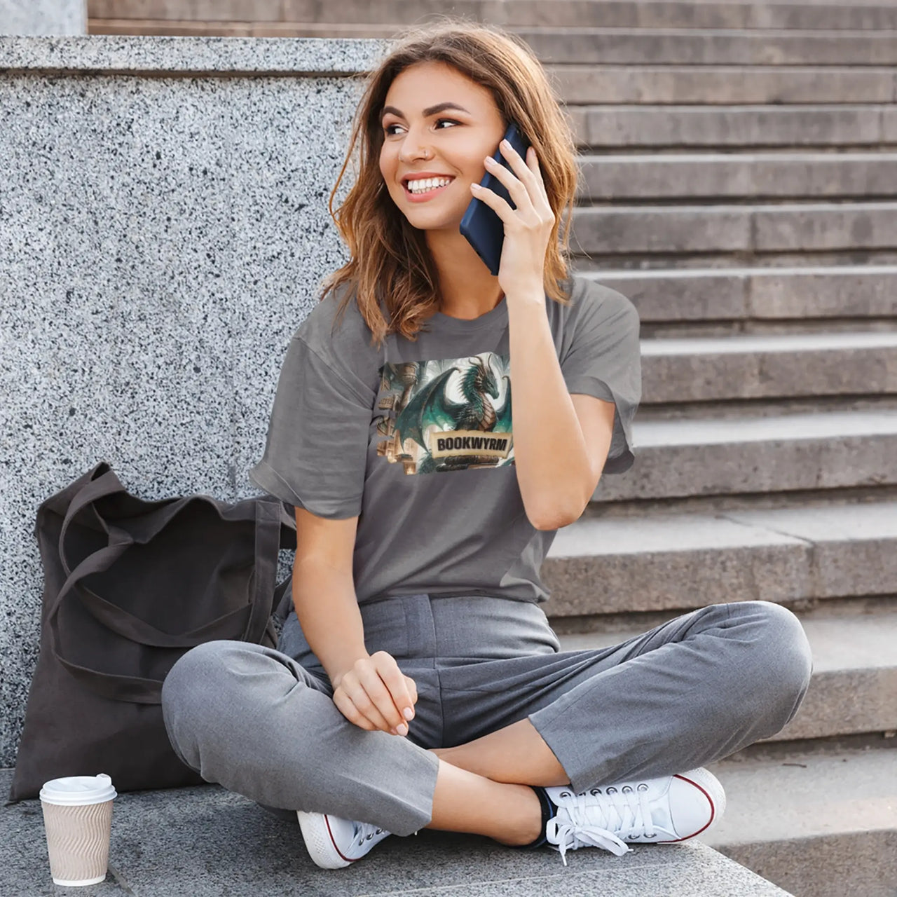 dark grey bookwyrm tee on a woman talking on the phone