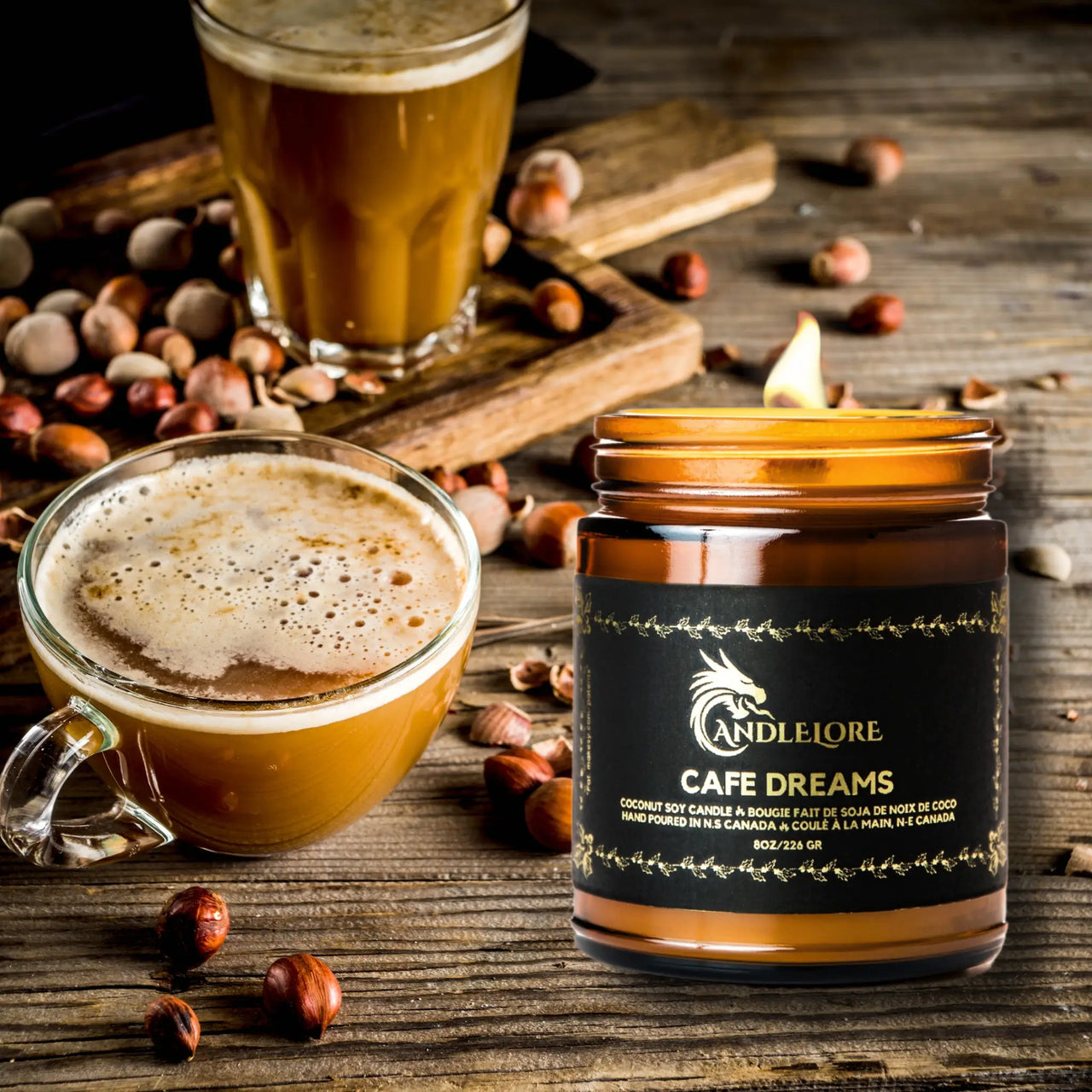 lit cafe dreams candle beside hazelnuts and coffee