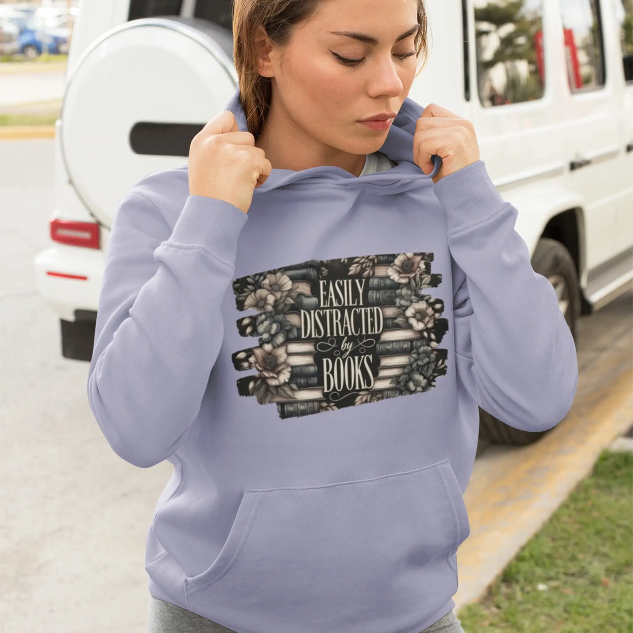 a woman wearing a violet Easily Distracted By Books Hoodie