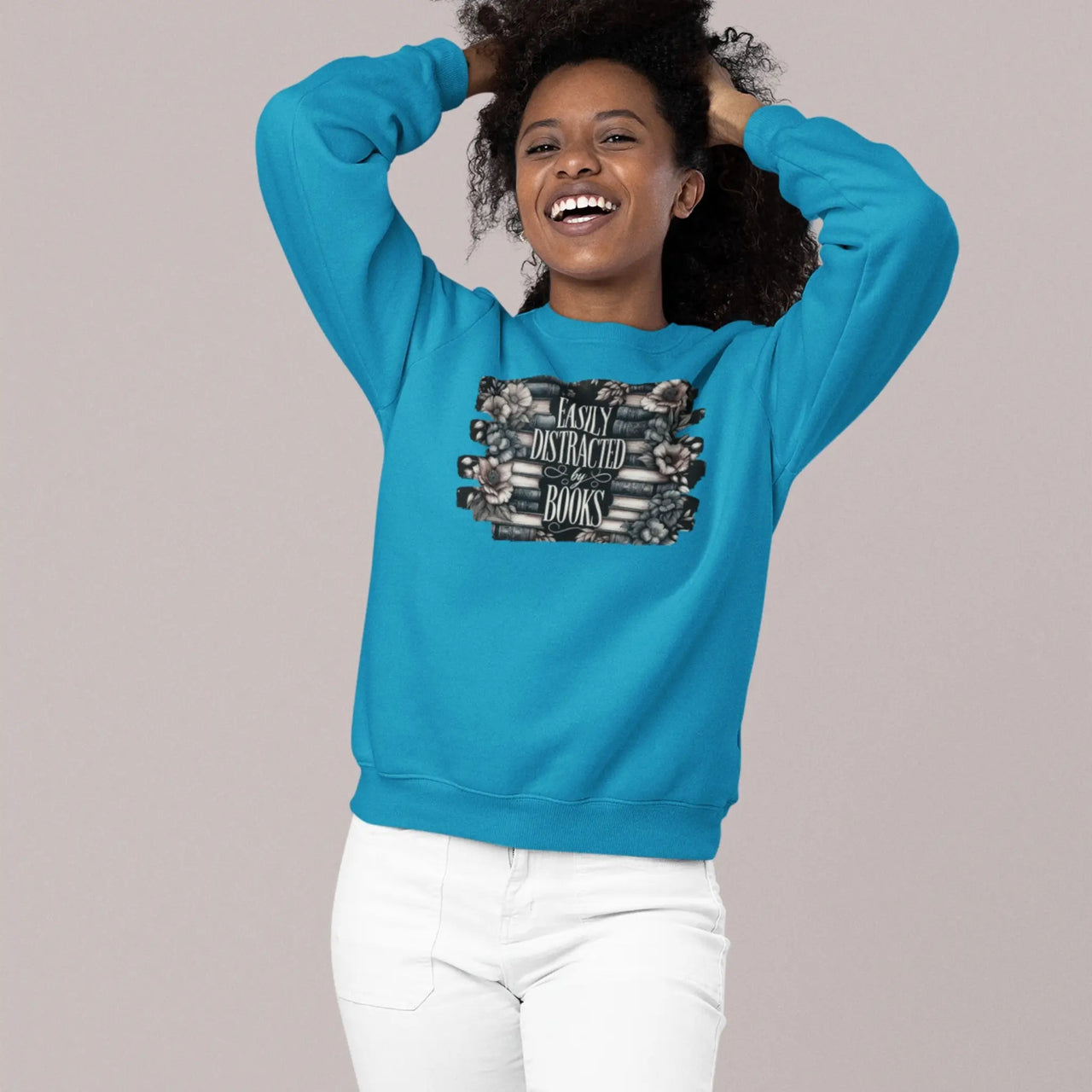 happy woman wearing a teal Easily Distracted By Books Sweatshirt