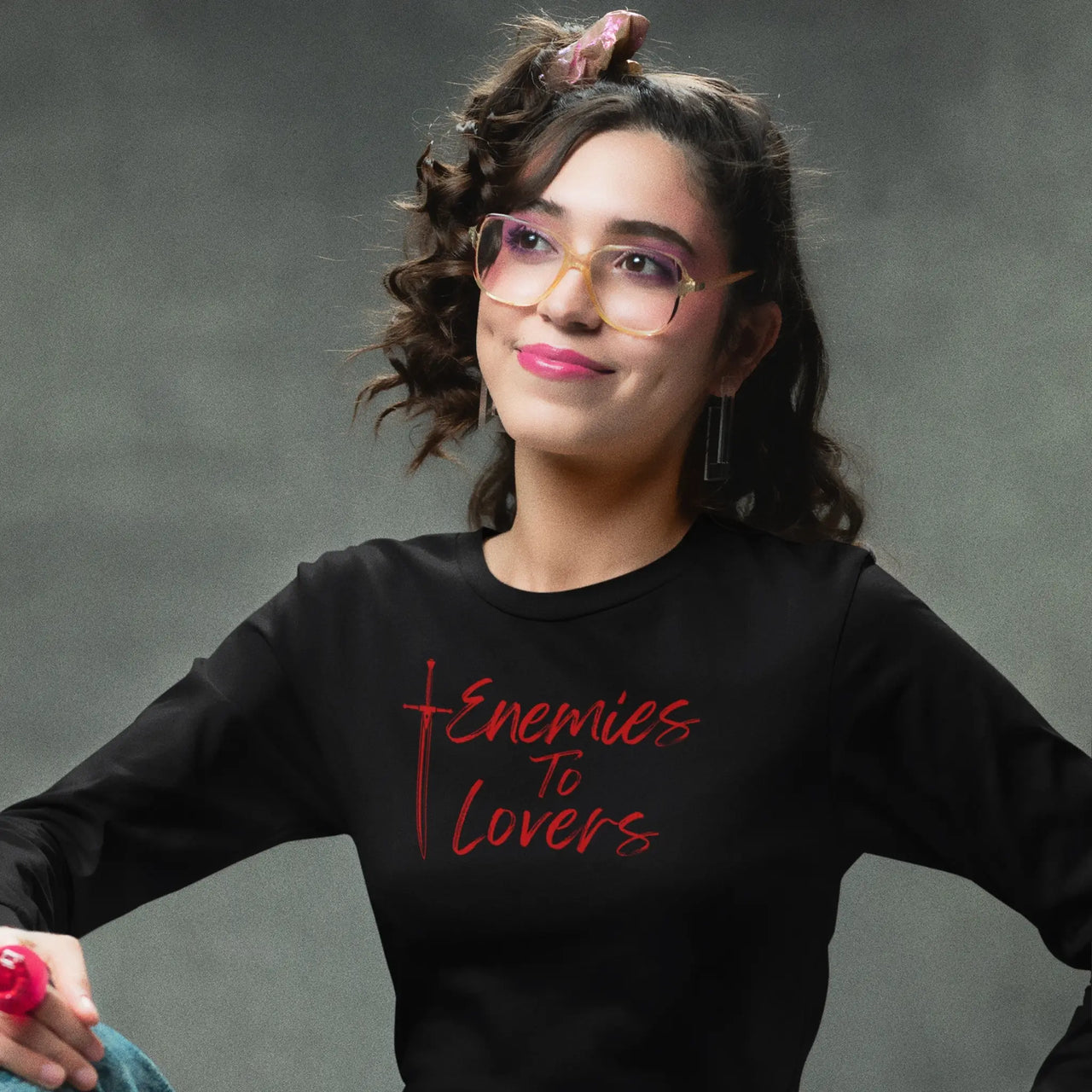 young woman wearing an Enemies To Lovers Long Tshirt in black with red writing