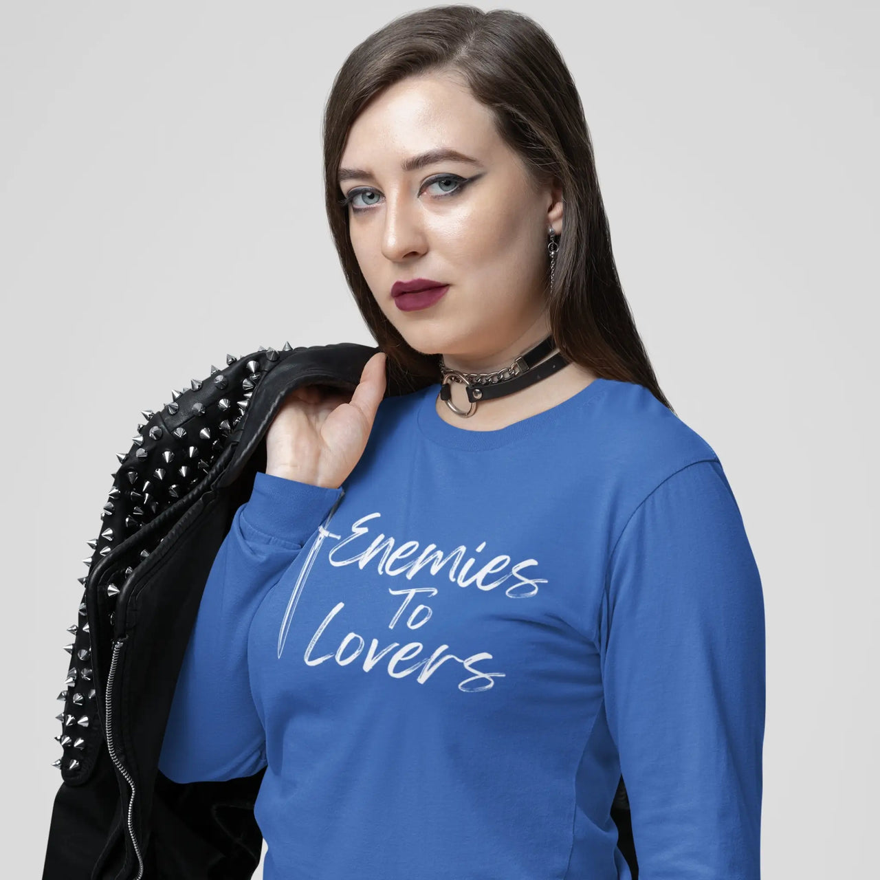 woman with a leather jacket wearing an Enemies To Lovers Long Tshirt in blue with white writing