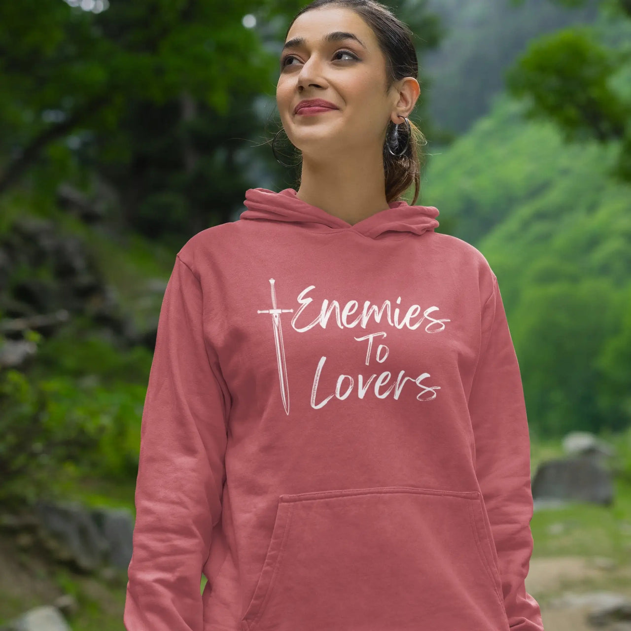 woman smiling while posing in a dark pink Enemies To Lovers Hoodie with white text