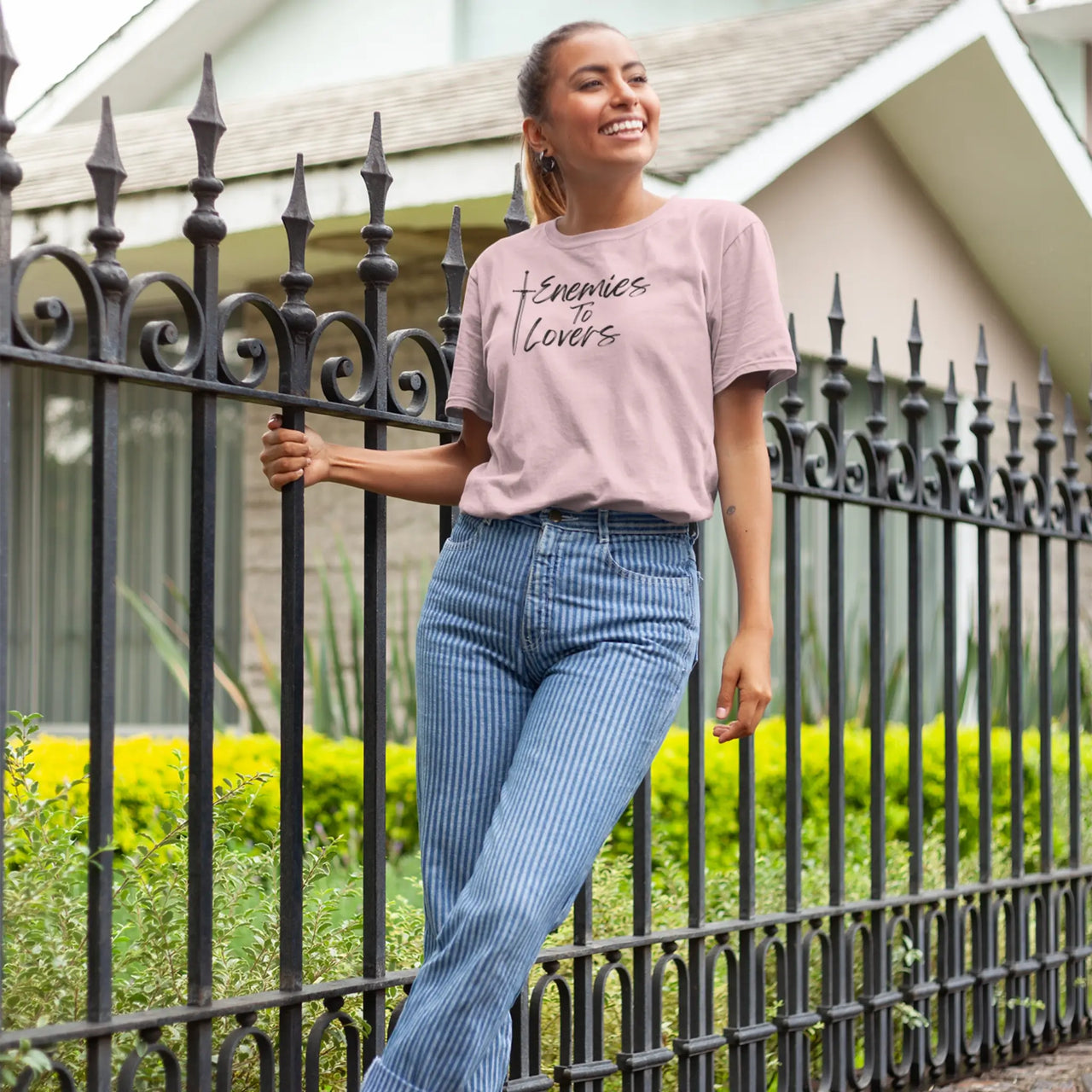 woman wearing a light pink Enemies To Lovers Tshirt