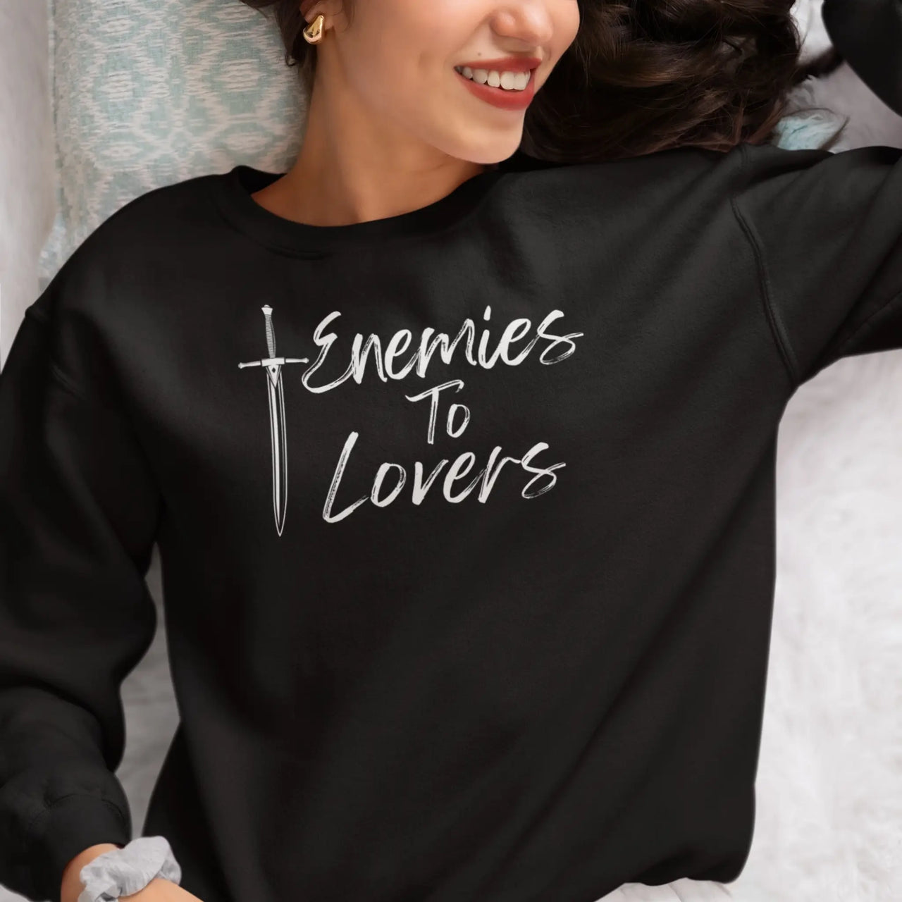 young woman wearing the black Enemies To Lovers sweatshirt