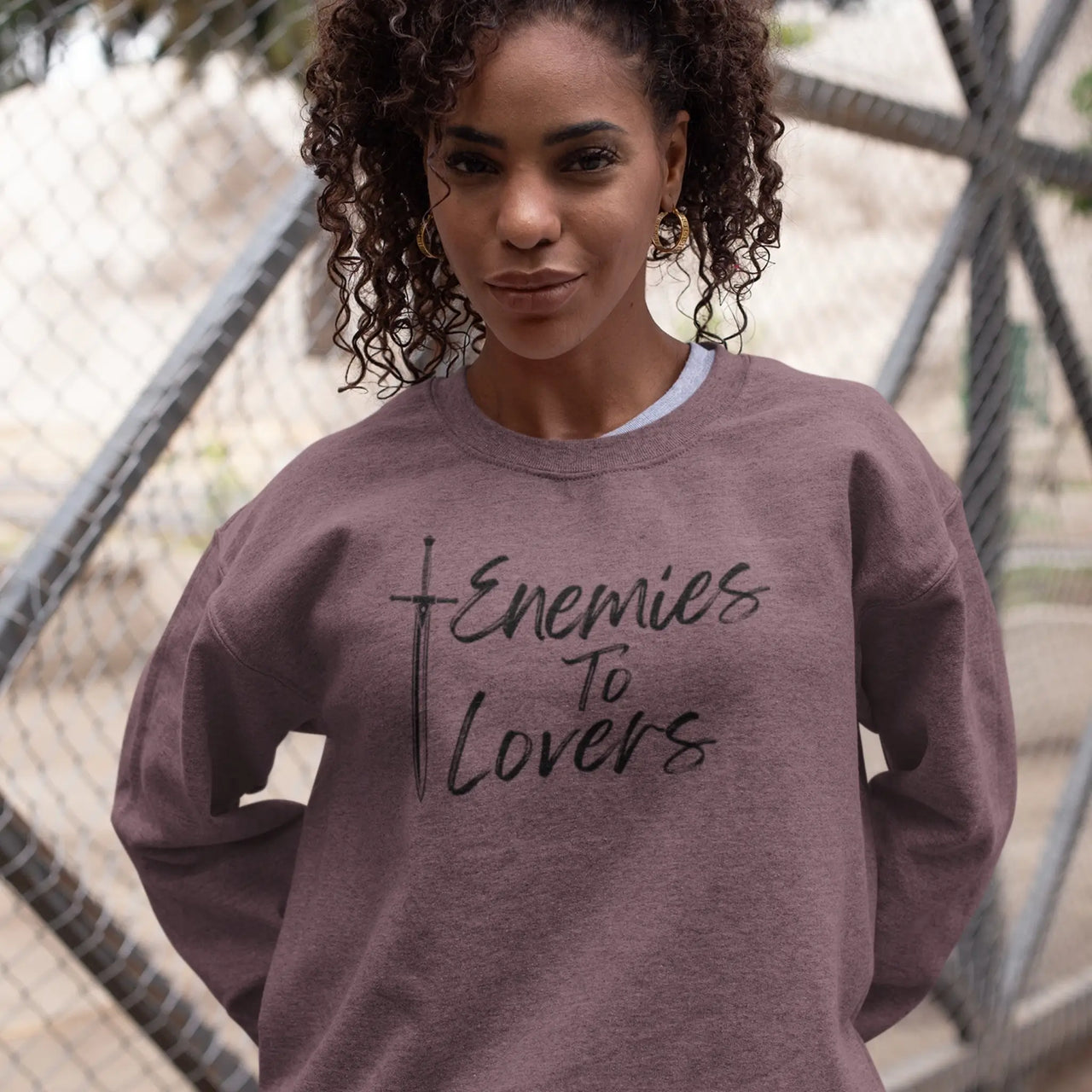 woman wearing the heather maroon Enemies To Lovers sweatshirt with black text